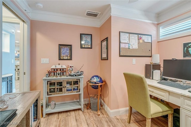 office space featuring light wood-type flooring, crown molding, baseboards, and visible vents
