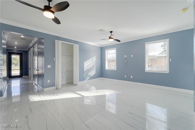 unfurnished room featuring ceiling fan, ornamental molding, and a healthy amount of sunlight