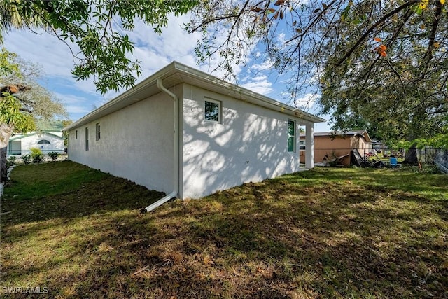 view of property exterior with a lawn