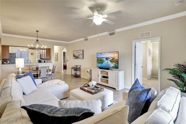 living room featuring visible vents, arched walkways, and crown molding