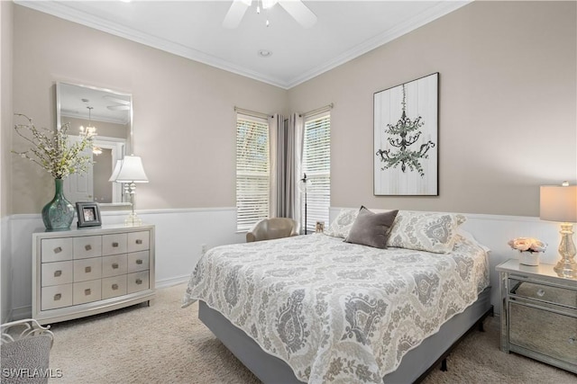 bedroom with ceiling fan, ornamental molding, and carpet floors