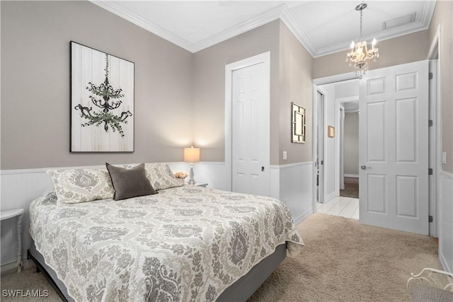 bedroom with crown molding, light carpet, a closet, and an inviting chandelier