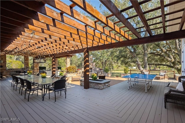 wooden terrace with a pergola and an outdoor stone fireplace