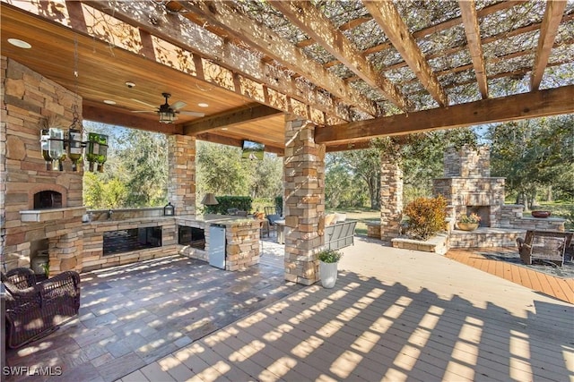 view of patio / terrace featuring an outdoor stone fireplace, area for grilling, and ceiling fan