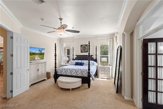 bedroom with a textured ceiling, ceiling fan, light carpet, ornamental molding, and ornate columns