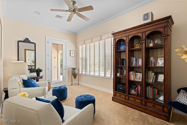 living area featuring ornamental molding, light carpet, and ceiling fan