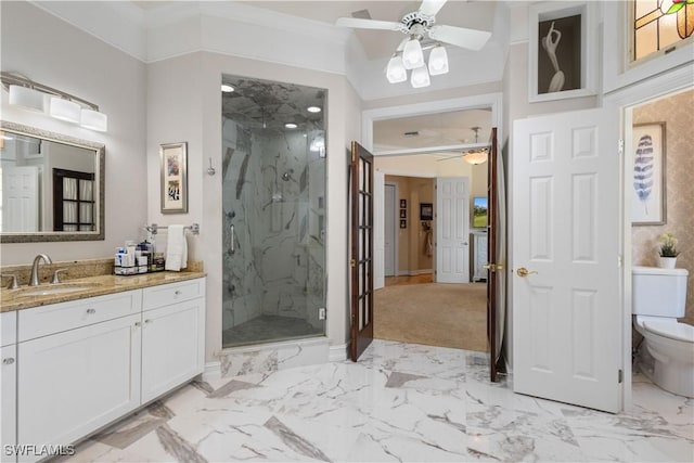 bathroom with toilet, a shower with door, ceiling fan, ornamental molding, and vanity