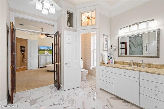 bathroom featuring toilet, ceiling fan, and vanity