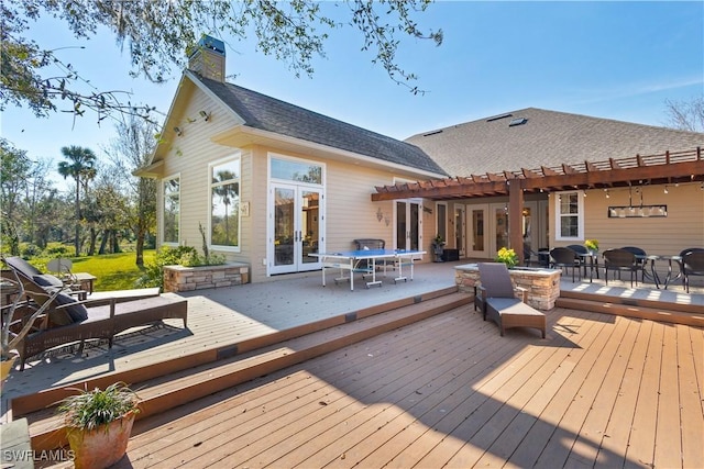 back of house with french doors, a deck, and an outdoor living space