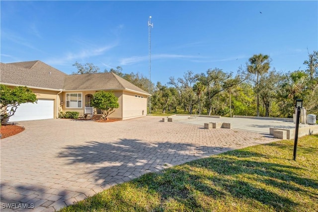 exterior space featuring a front lawn and a garage