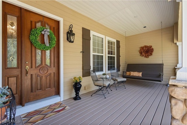 entrance to property featuring covered porch