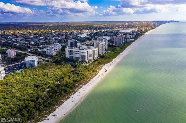 drone / aerial view featuring a beach view and a water view