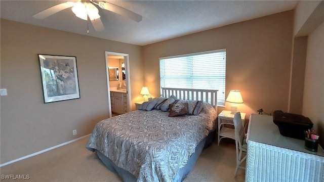 bedroom featuring ceiling fan, light colored carpet, and ensuite bathroom