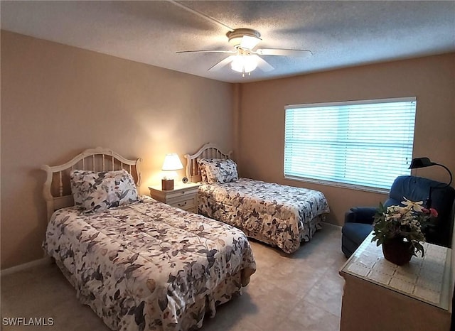 bedroom with a textured ceiling and ceiling fan