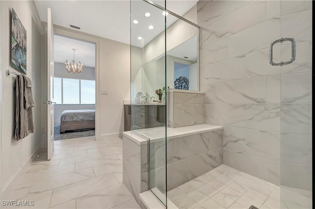bathroom featuring vanity, an inviting chandelier, and walk in shower