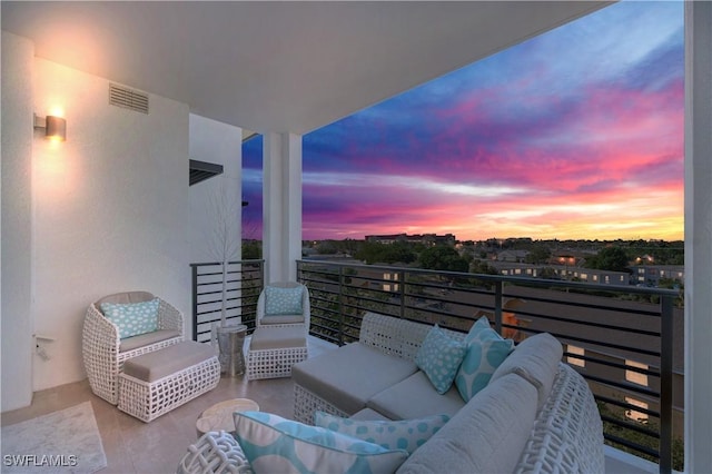 balcony at dusk featuring an outdoor hangout area