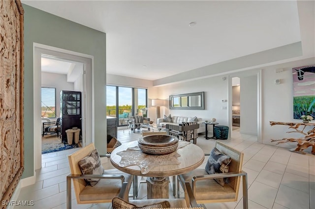 dining space featuring light tile patterned floors