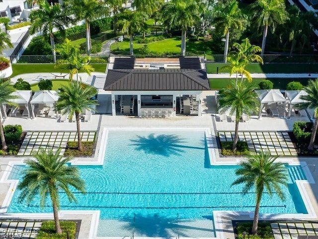 view of pool featuring exterior bar and a patio area