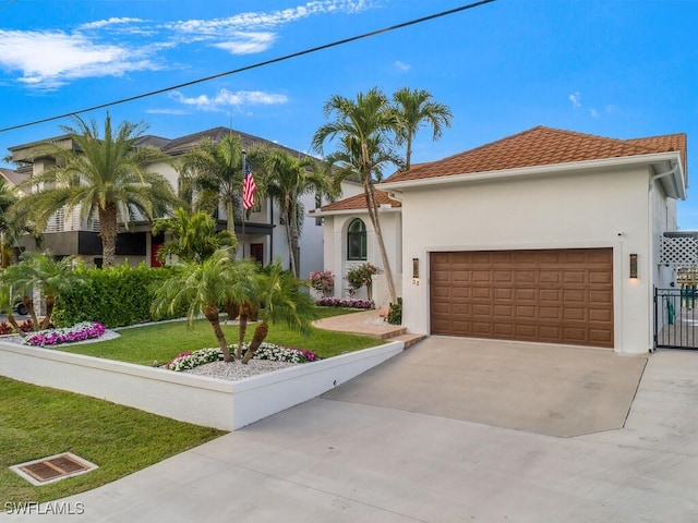 mediterranean / spanish house with a front lawn and a garage