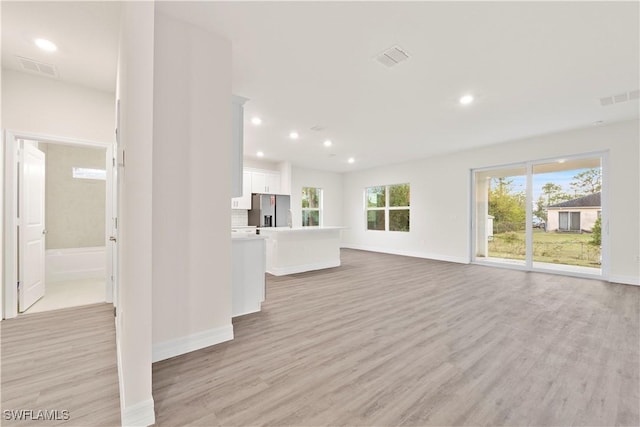 unfurnished living room featuring light wood-type flooring