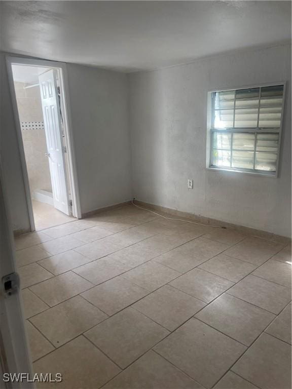 unfurnished room featuring light tile patterned floors