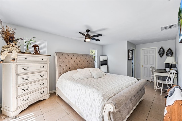 tiled bedroom with ceiling fan