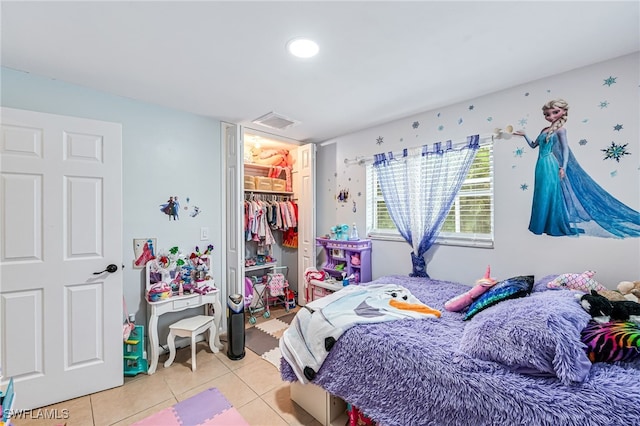 bedroom with light tile patterned floors and a closet