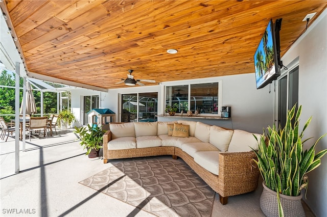 view of patio / terrace with glass enclosure, outdoor lounge area, and ceiling fan