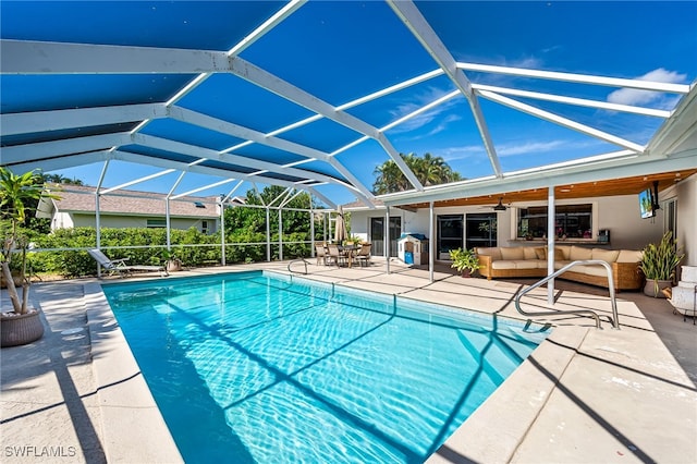 view of swimming pool featuring a patio area, an outdoor living space, ceiling fan, and glass enclosure