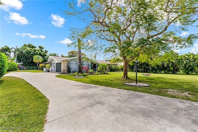 ranch-style home with a garage and a front yard