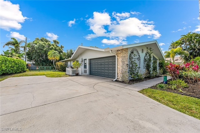 view of property exterior with a garage and a lawn