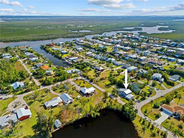 birds eye view of property featuring a water view and a residential view