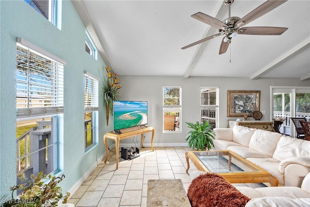 living area with a healthy amount of sunlight, vaulted ceiling with beams, baseboards, and light tile patterned flooring