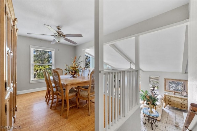 dining area with vaulted ceiling with beams, ceiling fan, light wood-style flooring, and baseboards