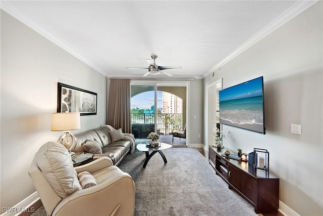 living room featuring a ceiling fan, baseboards, and crown molding