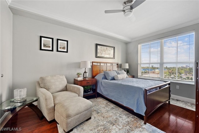 bedroom with a ceiling fan, crown molding, baseboards, and wood finished floors