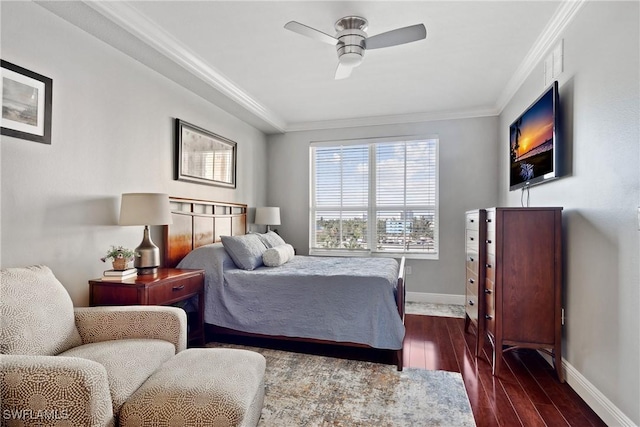 bedroom featuring crown molding, dark wood finished floors, baseboards, and ceiling fan