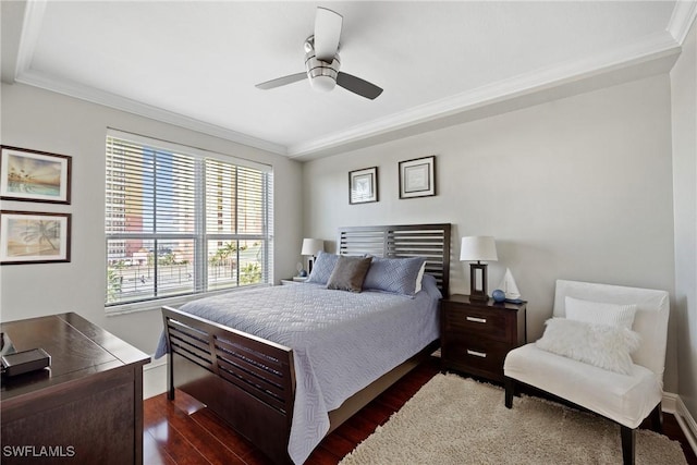 bedroom featuring dark wood-type flooring, crown molding, and ceiling fan