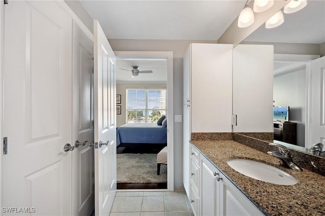 bathroom with ensuite bathroom, vanity, and tile patterned floors