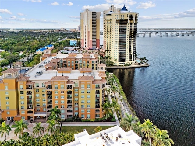 birds eye view of property featuring a water view and a city view