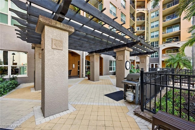 view of patio / terrace with a grill, fence, and a pergola