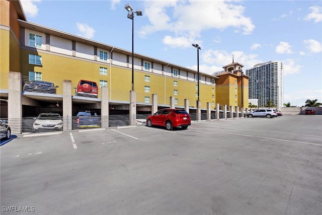 uncovered parking lot featuring a view of city