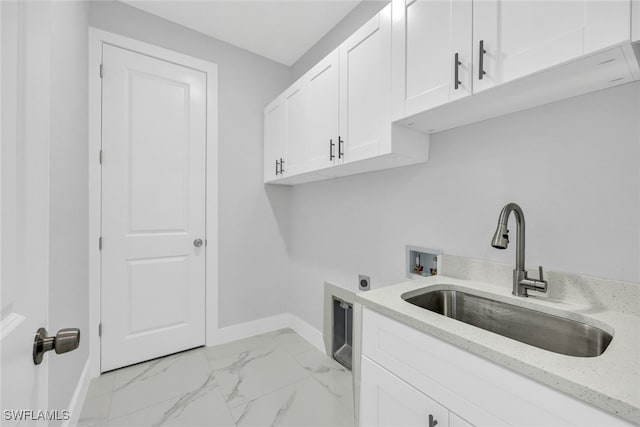 washroom with cabinet space, marble finish floor, hookup for an electric dryer, washer hookup, and a sink