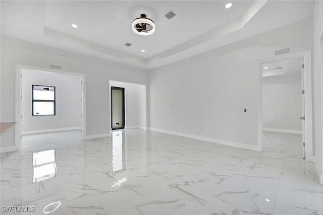 spare room featuring recessed lighting, visible vents, baseboards, marble finish floor, and a tray ceiling