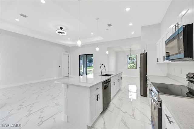 kitchen featuring pendant lighting, white cabinets, a sink, light stone countertops, and black appliances