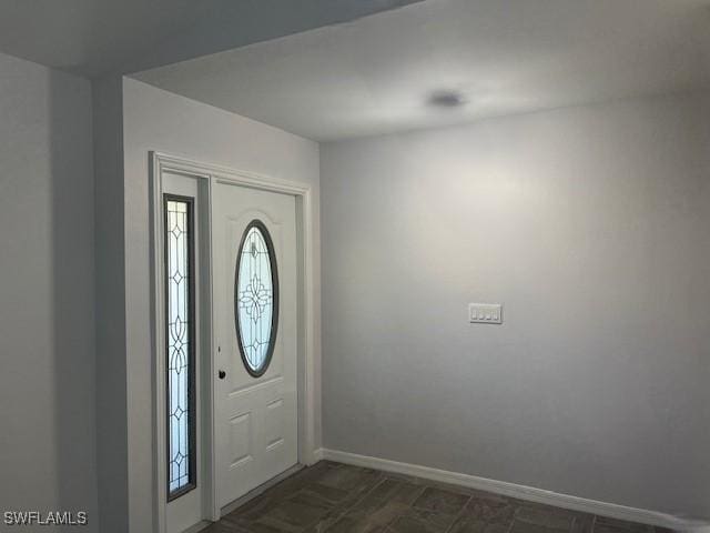 entryway featuring baseboards