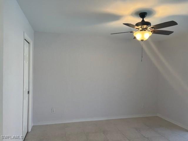 empty room featuring baseboards and a ceiling fan