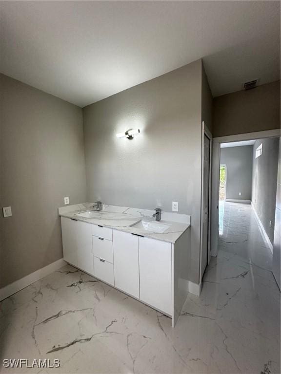 2610 34th St SW, Lehigh Acres, FL 33976 - bathroom with baseboards, marble finish flooring, and double vanity