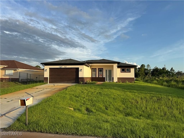2610 34th St SW, Lehigh Acres, FL 33976 - view of front of home featuring stucco siding, driveway, an attached garage, and a front yard