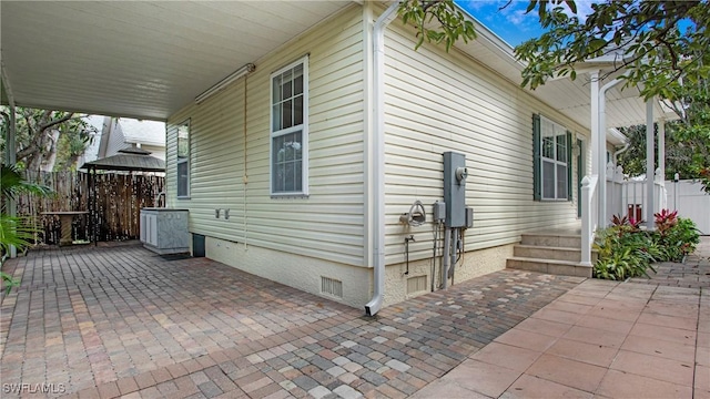 view of side of property featuring a patio